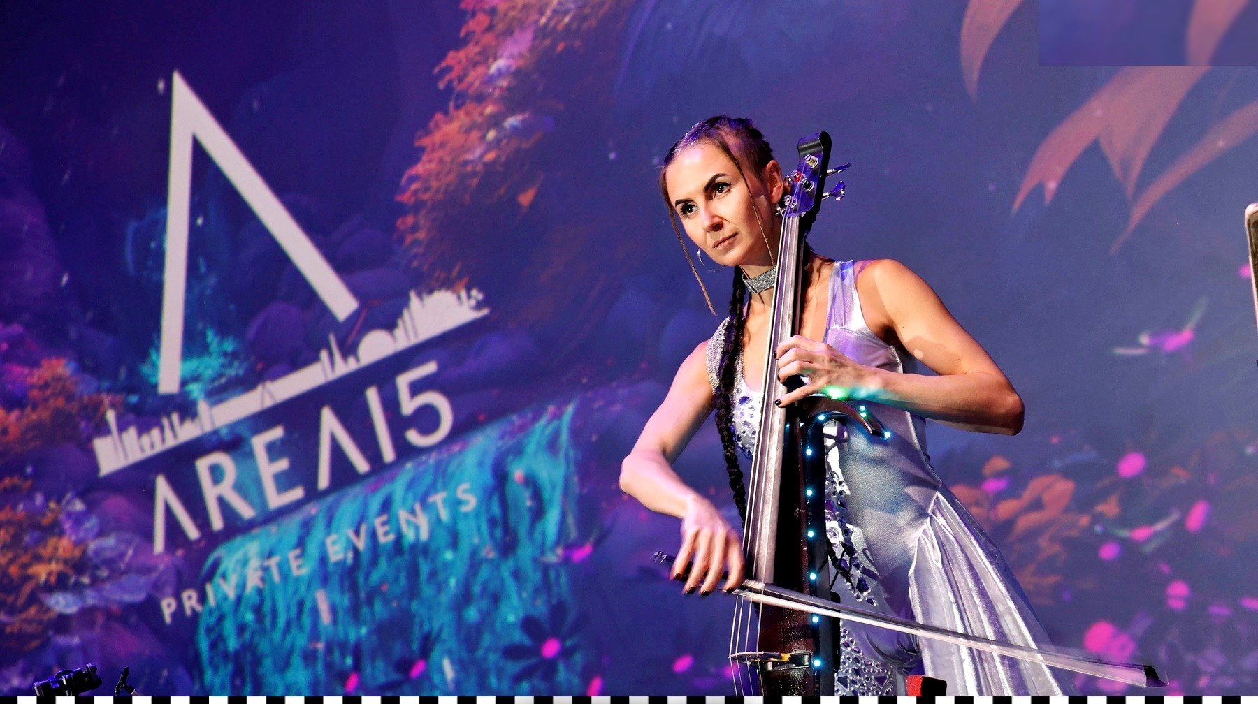 Elenka playing electric cello on stage at AREA15, Las Vegas